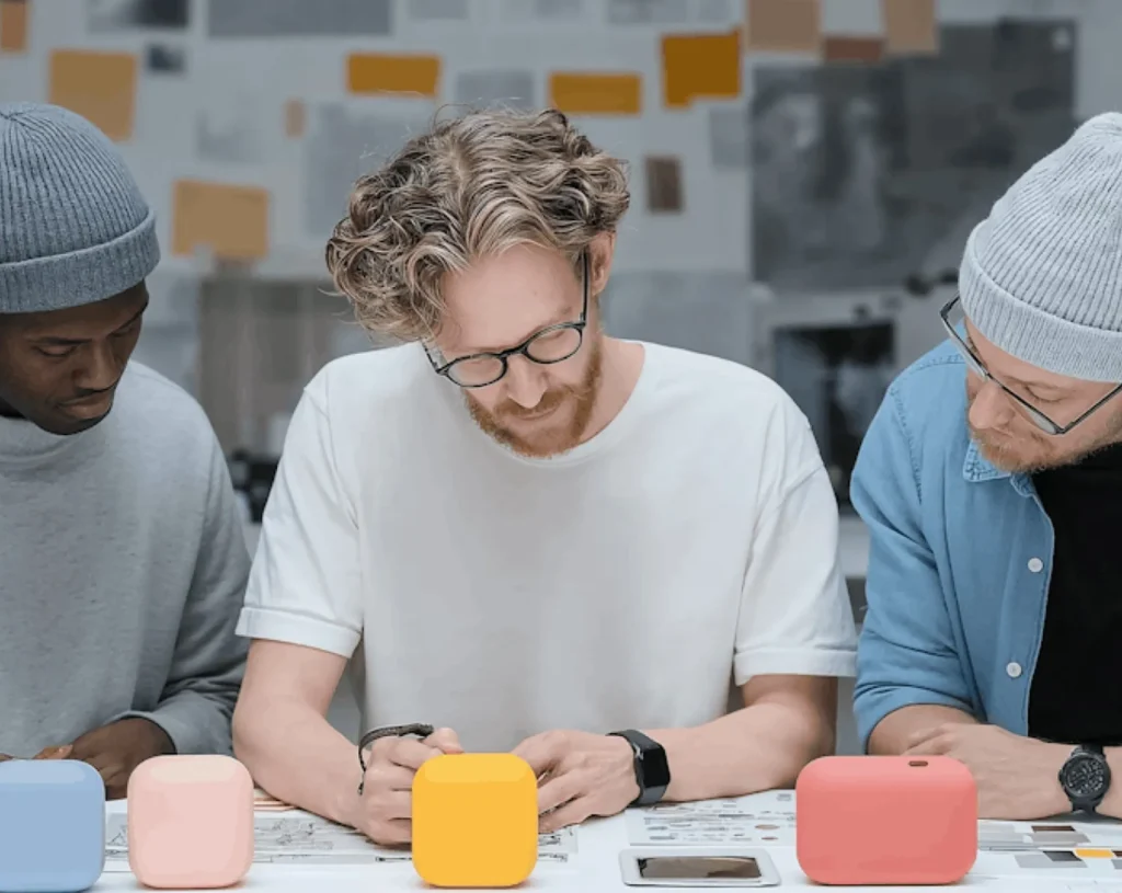 our contact us Three people working at a table.